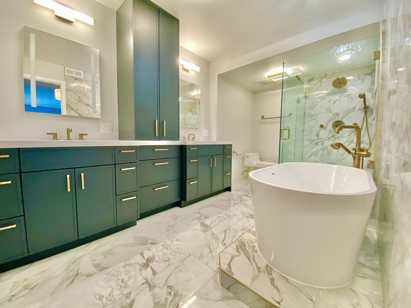 Emerald vanity bath with brass fixtures