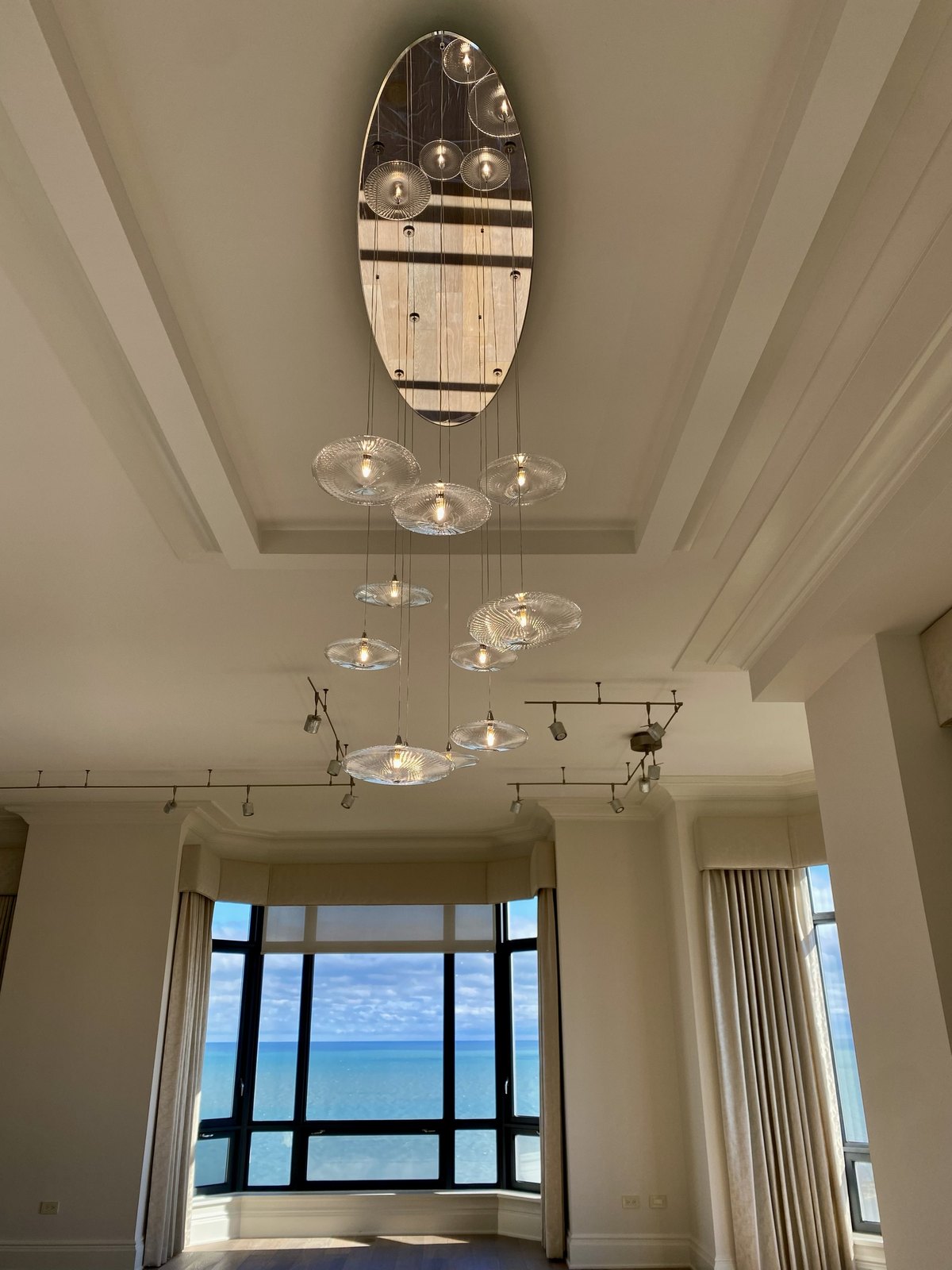 Lakefront living room with cascading glass chandelier
